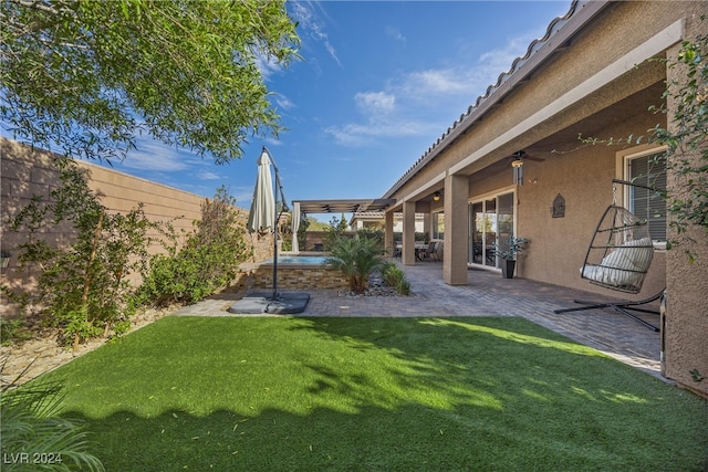 view of yard featuring ceiling fan and a patio area