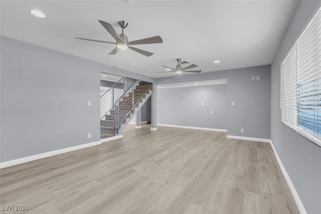 unfurnished living room featuring light hardwood / wood-style floors and ceiling fan