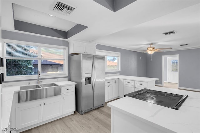 kitchen featuring white cabinets, stainless steel fridge with ice dispenser, and sink