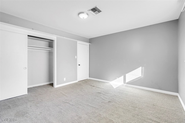 unfurnished bedroom featuring a closet and carpet