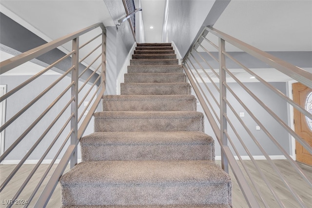 stairway with hardwood / wood-style floors