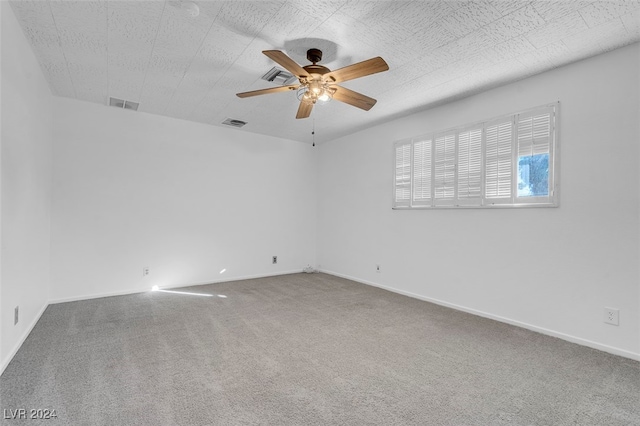 empty room with ceiling fan and carpet floors