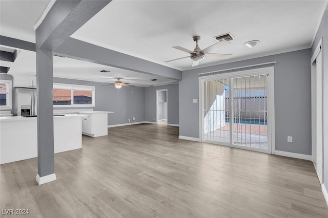 unfurnished living room with light hardwood / wood-style flooring and ceiling fan