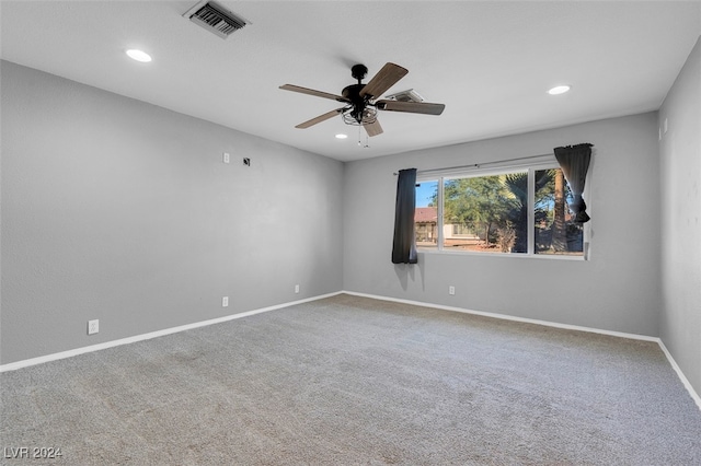 carpeted empty room featuring ceiling fan