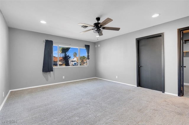 unfurnished bedroom with ceiling fan and carpet