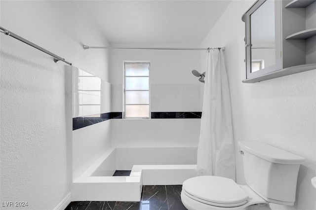 bathroom featuring curtained shower and toilet