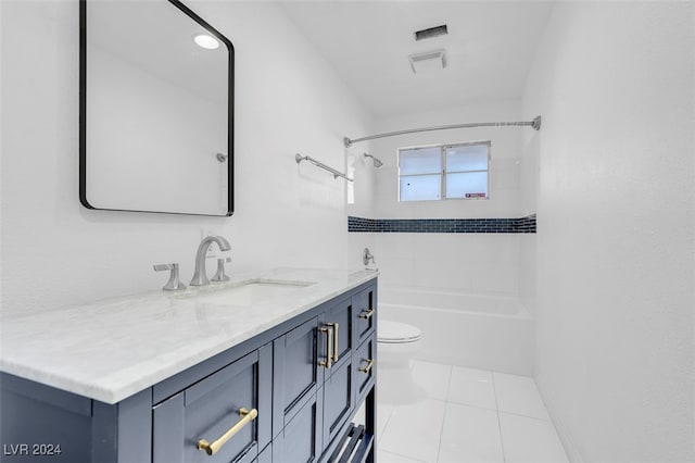 bathroom with toilet, vanity, and tile patterned flooring