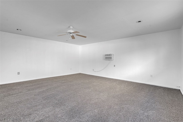 unfurnished room featuring ceiling fan, a wall mounted AC, and carpet floors