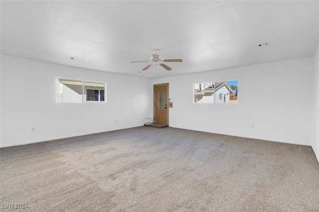 carpeted empty room with ceiling fan