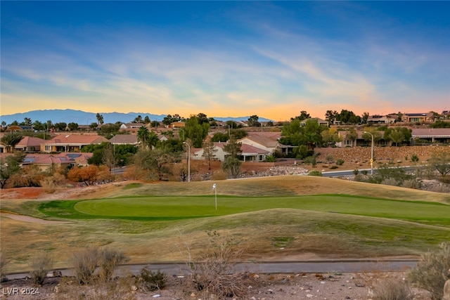 view of property's community featuring a mountain view and a yard