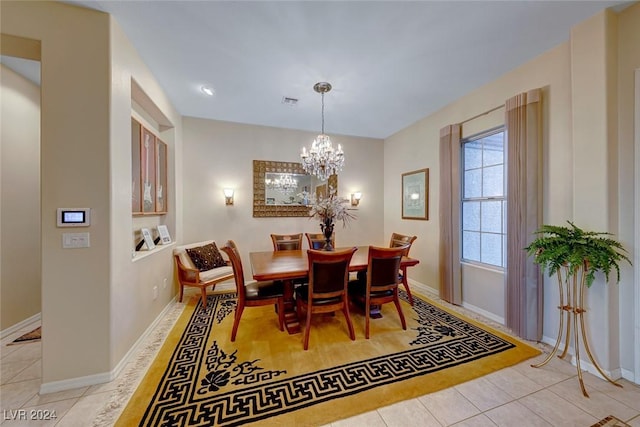 dining room featuring visible vents, a notable chandelier, baseboards, and light tile patterned floors