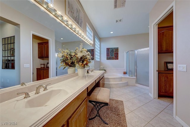 full bathroom with double vanity, a stall shower, tile patterned floors, a garden tub, and a sink