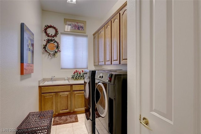 washroom with cabinet space, light tile patterned floors, a sink, and independent washer and dryer