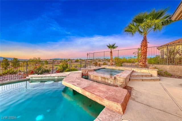 view of swimming pool with an in ground hot tub, a fenced backyard, and a fenced in pool