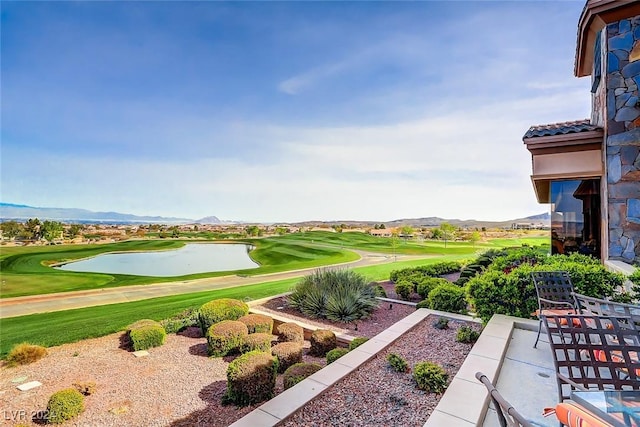 view of home's community with view of golf course and a mountain view