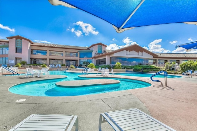 community pool with a patio area