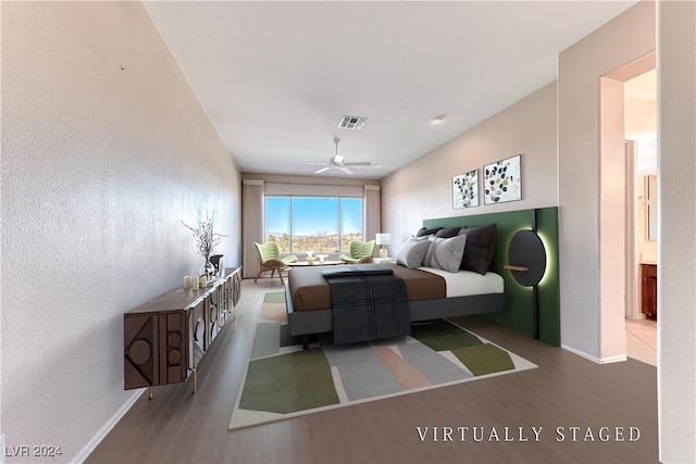 bedroom featuring visible vents, ceiling fan, baseboards, and wood finished floors