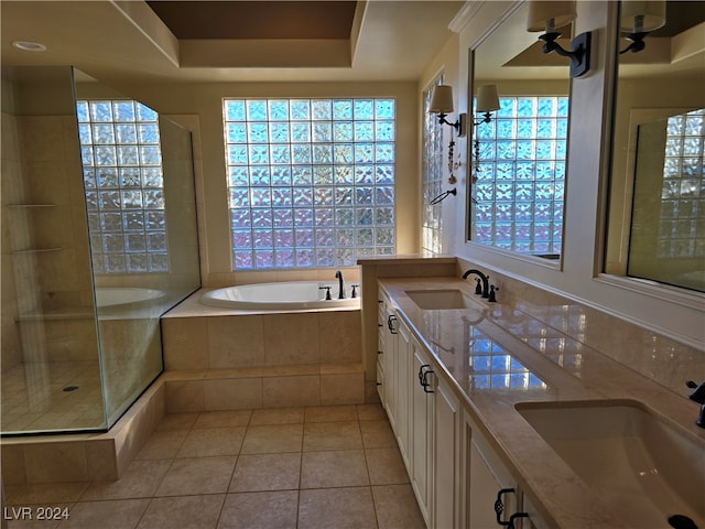 bathroom featuring a raised ceiling, vanity, tile patterned flooring, and separate shower and tub