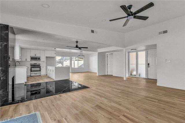 kitchen with white cabinetry, light hardwood / wood-style flooring, and stainless steel appliances