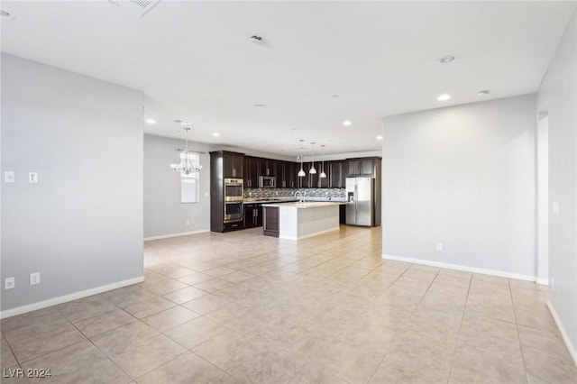 unfurnished living room with light tile patterned flooring and an inviting chandelier