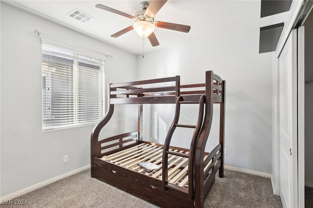 bedroom with carpet flooring, ceiling fan, and a closet