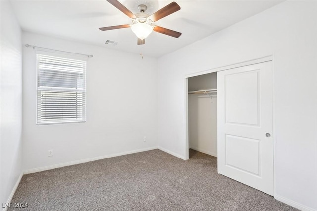 unfurnished bedroom featuring carpet, ceiling fan, and a closet