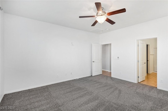 unfurnished bedroom with ceiling fan and light carpet