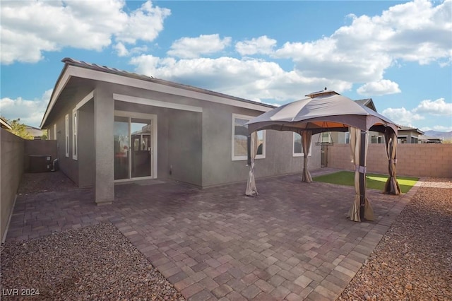 back of house with a gazebo, cooling unit, and a patio area