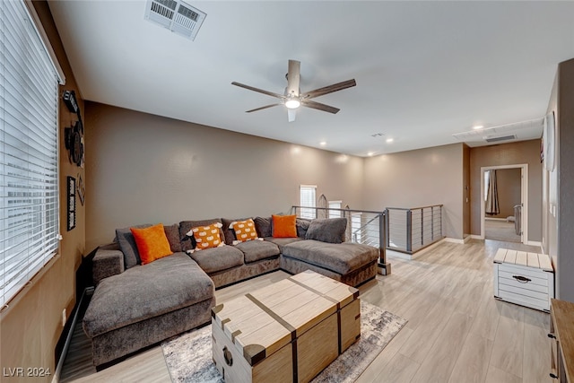 living room with ceiling fan and light hardwood / wood-style floors