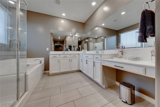 bathroom with vanity, tile patterned floors, and plus walk in shower