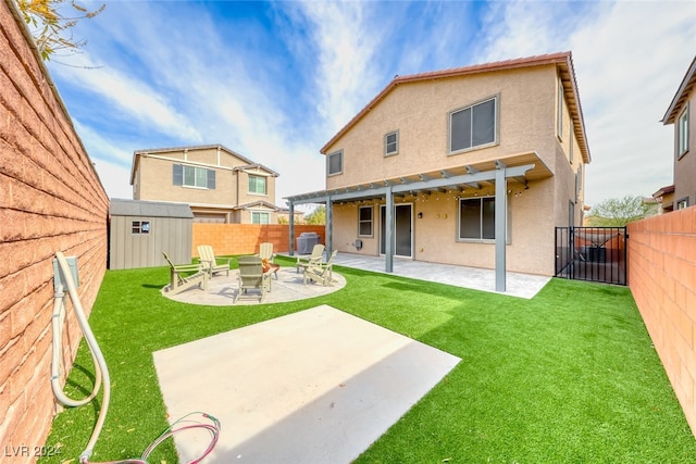 rear view of house with a patio area, a lawn, and a shed