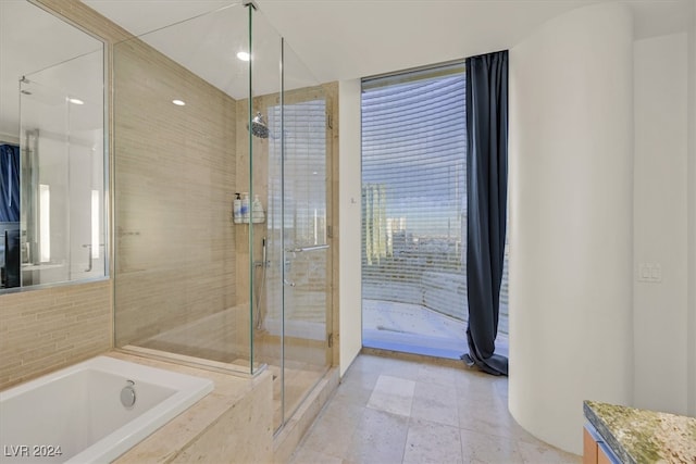 bathroom with vanity, tile patterned flooring, and separate shower and tub