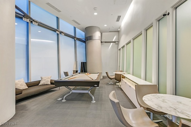 game room with expansive windows and billiards