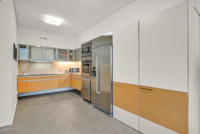 kitchen featuring light tile patterned floors and stainless steel appliances