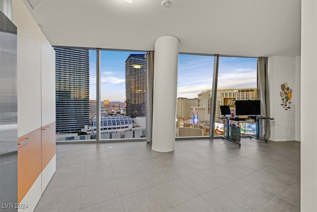 tiled empty room with floor to ceiling windows