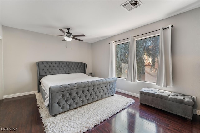 bedroom with ceiling fan and dark hardwood / wood-style flooring