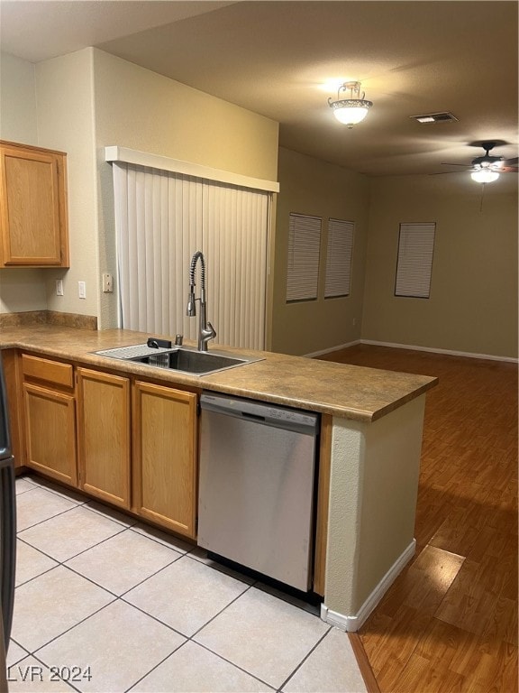 kitchen featuring dishwasher, kitchen peninsula, sink, ceiling fan, and light hardwood / wood-style flooring