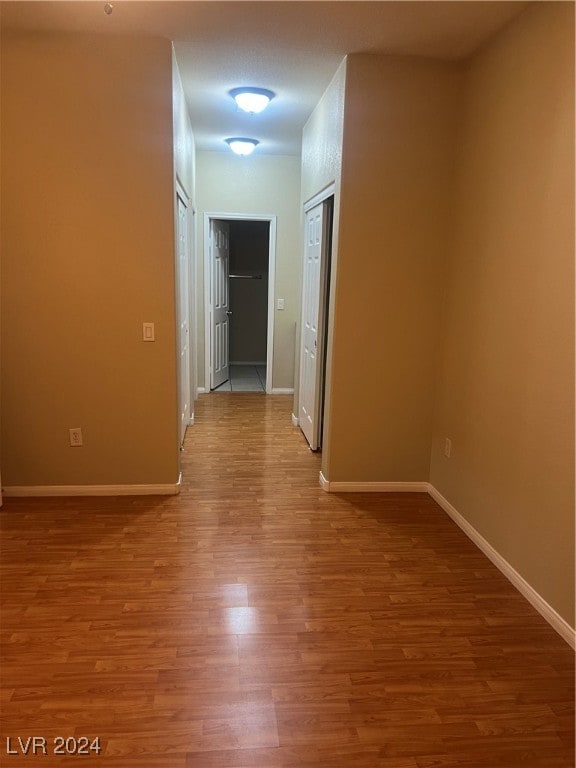 hallway with hardwood / wood-style floors