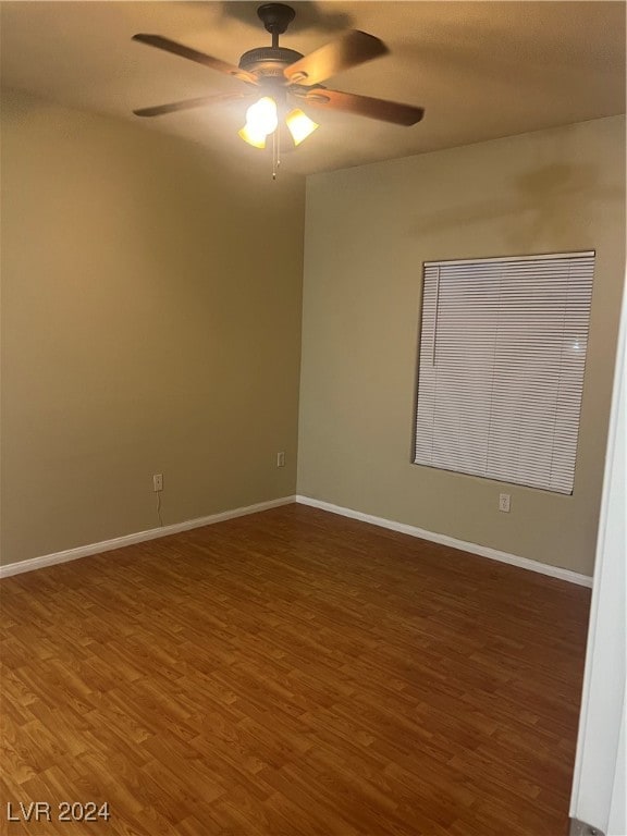 empty room featuring dark hardwood / wood-style flooring and ceiling fan