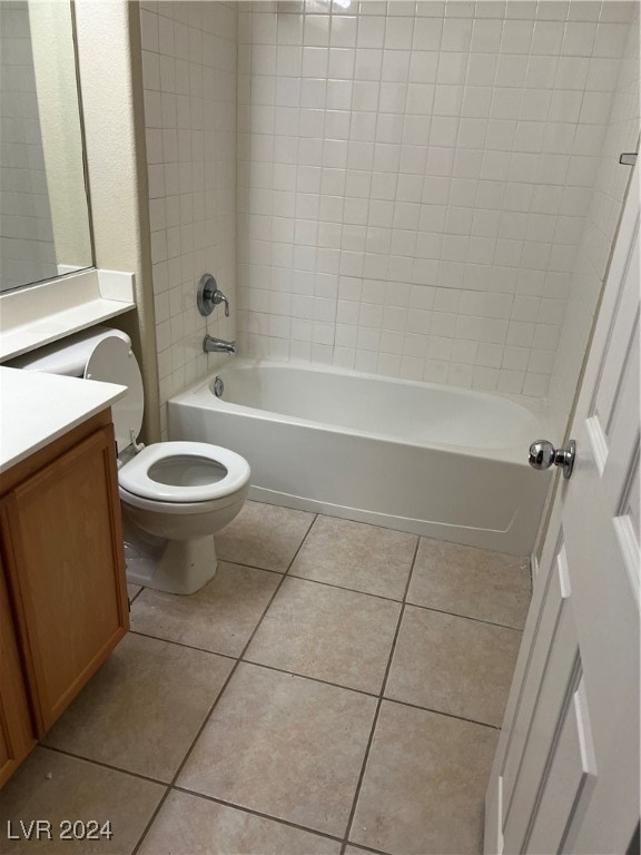 full bathroom with vanity, tile patterned floors, toilet, and tiled shower / bath combo