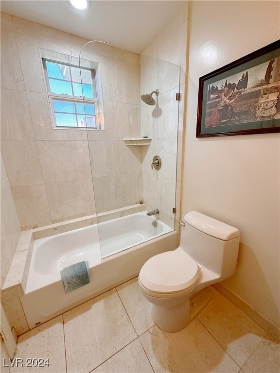 bathroom with tile patterned flooring, toilet, and tiled shower / bath combo