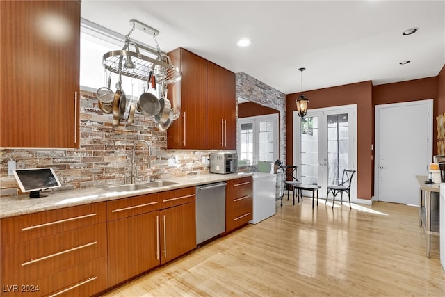 kitchen featuring light hardwood / wood-style floors, dishwasher, decorative light fixtures, and french doors