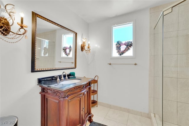 bathroom with vanity, a wealth of natural light, tile patterned flooring, and walk in shower