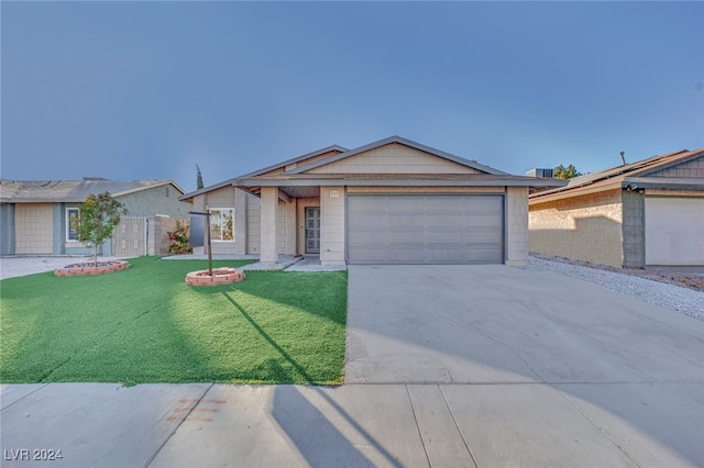 ranch-style house featuring a front lawn and a garage