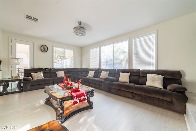 living room with ceiling fan and light hardwood / wood-style flooring