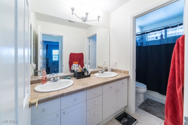 bathroom with vanity, tile patterned floors, and toilet