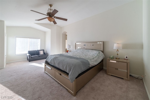 carpeted bedroom featuring ceiling fan and vaulted ceiling