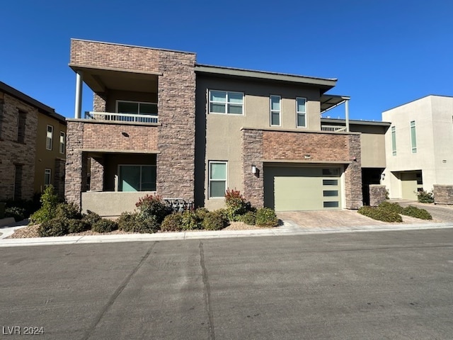 view of front facade featuring a balcony and a garage