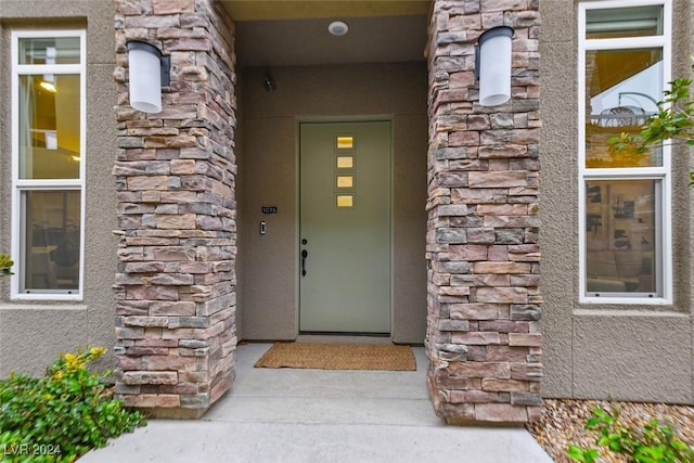 property entrance with stone siding