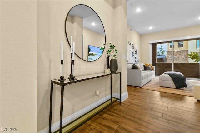 interior space with baseboards, visible vents, wood finished floors, and recessed lighting